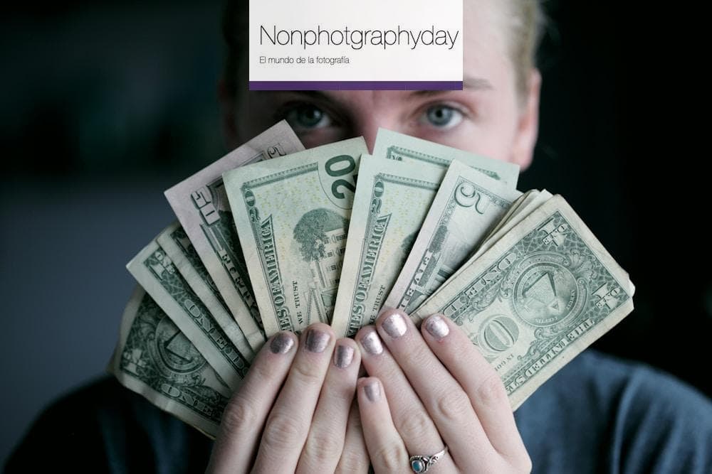person holding fan of U.S. dollars banknote